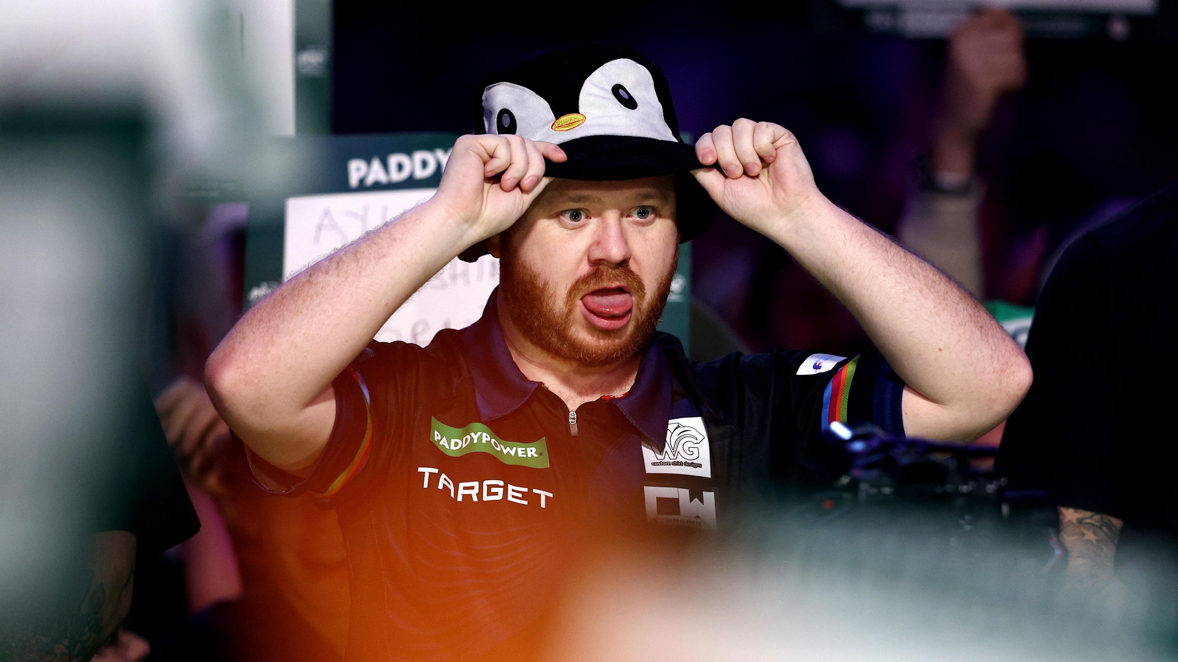 Justin Hood sticking his tongue out while wearing a penguin bucket hat