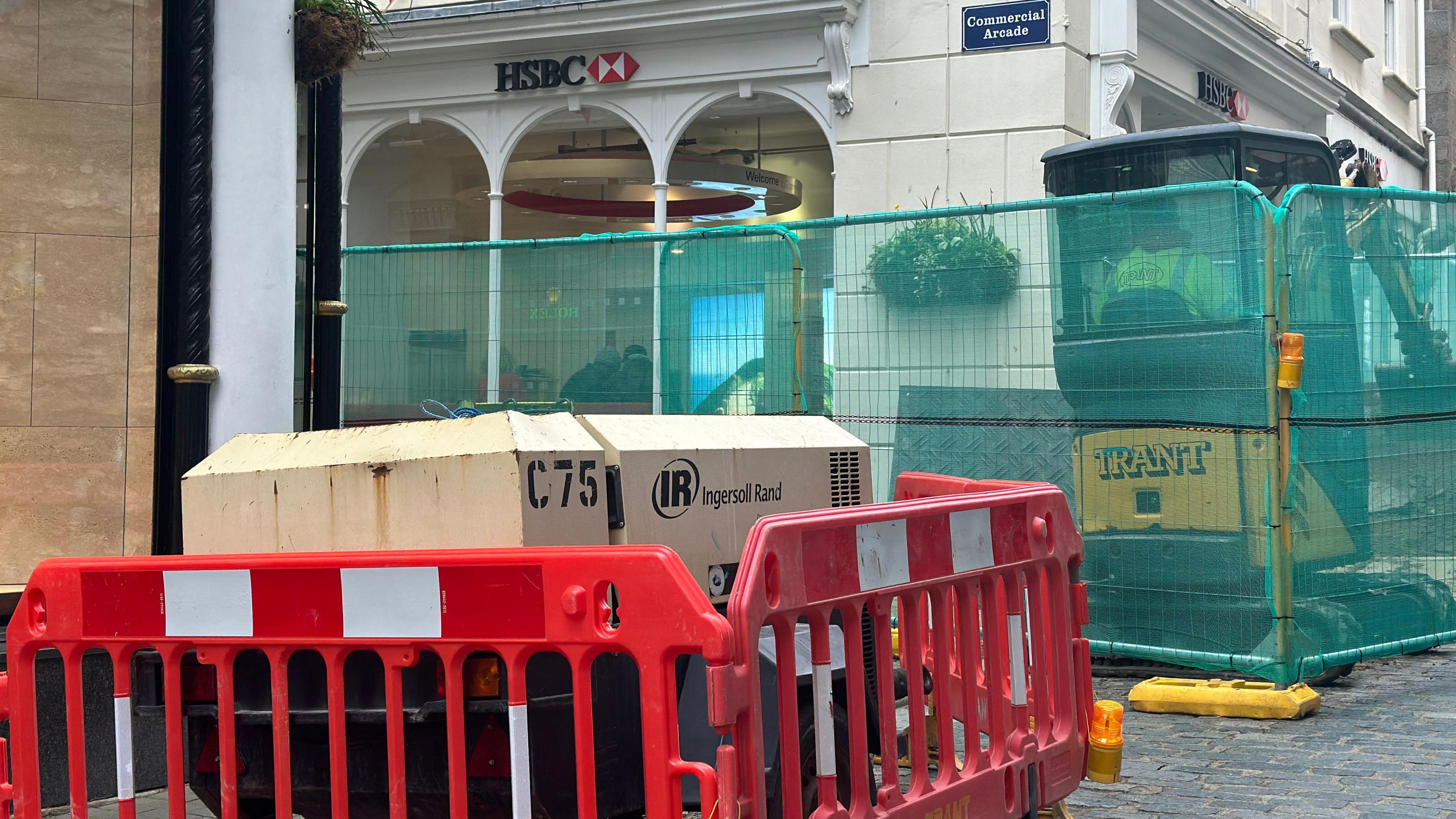 A generator and barriers on the corner of commercial arcade 