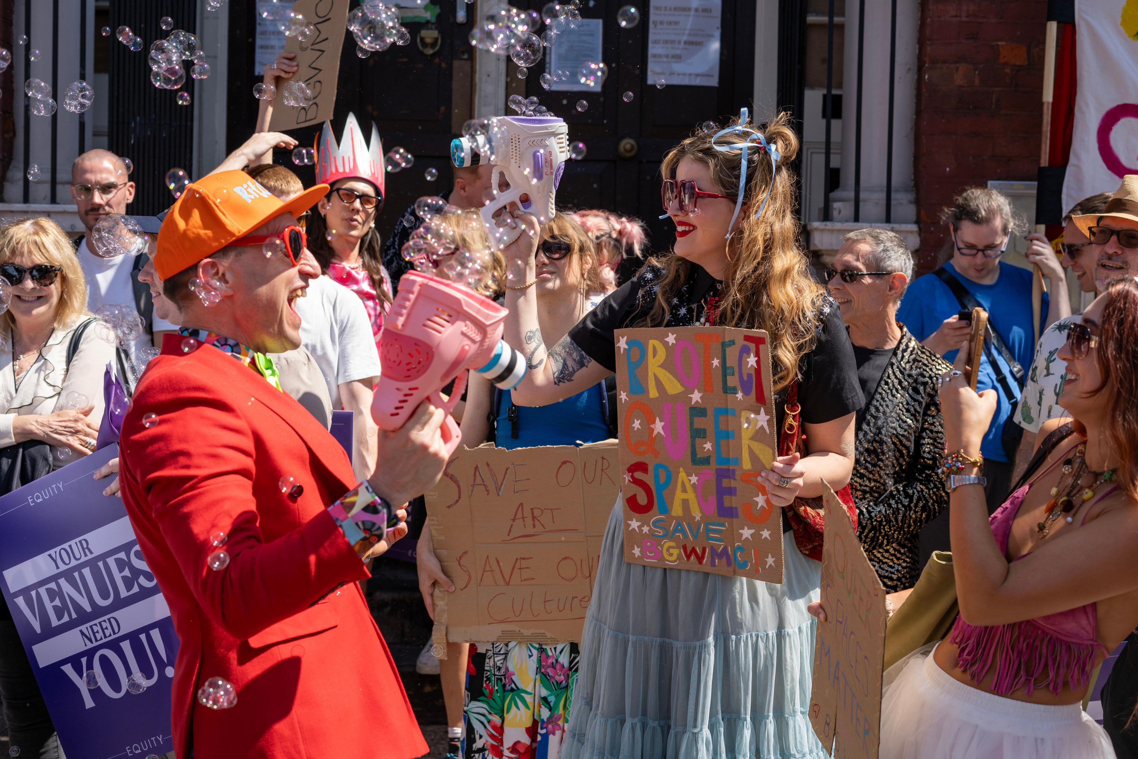 Protesters gather outside Bethnal Green Working Men's Club with signs reading 'save our venues' and 'hands off our queer places'