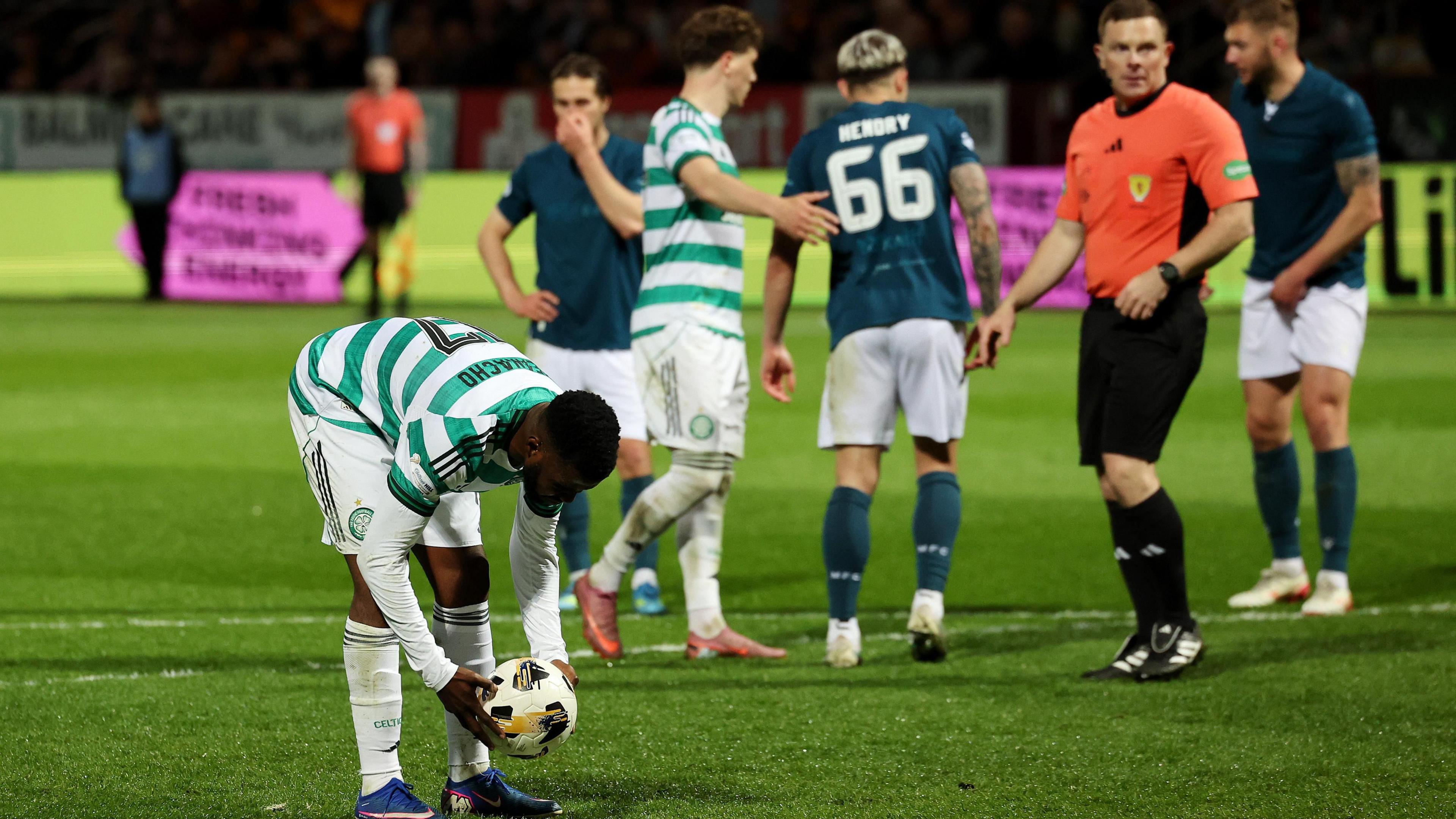 Celtic's Kelechi Iheanacho places the ball on the spot before scoring their side's third goal from a penalty.