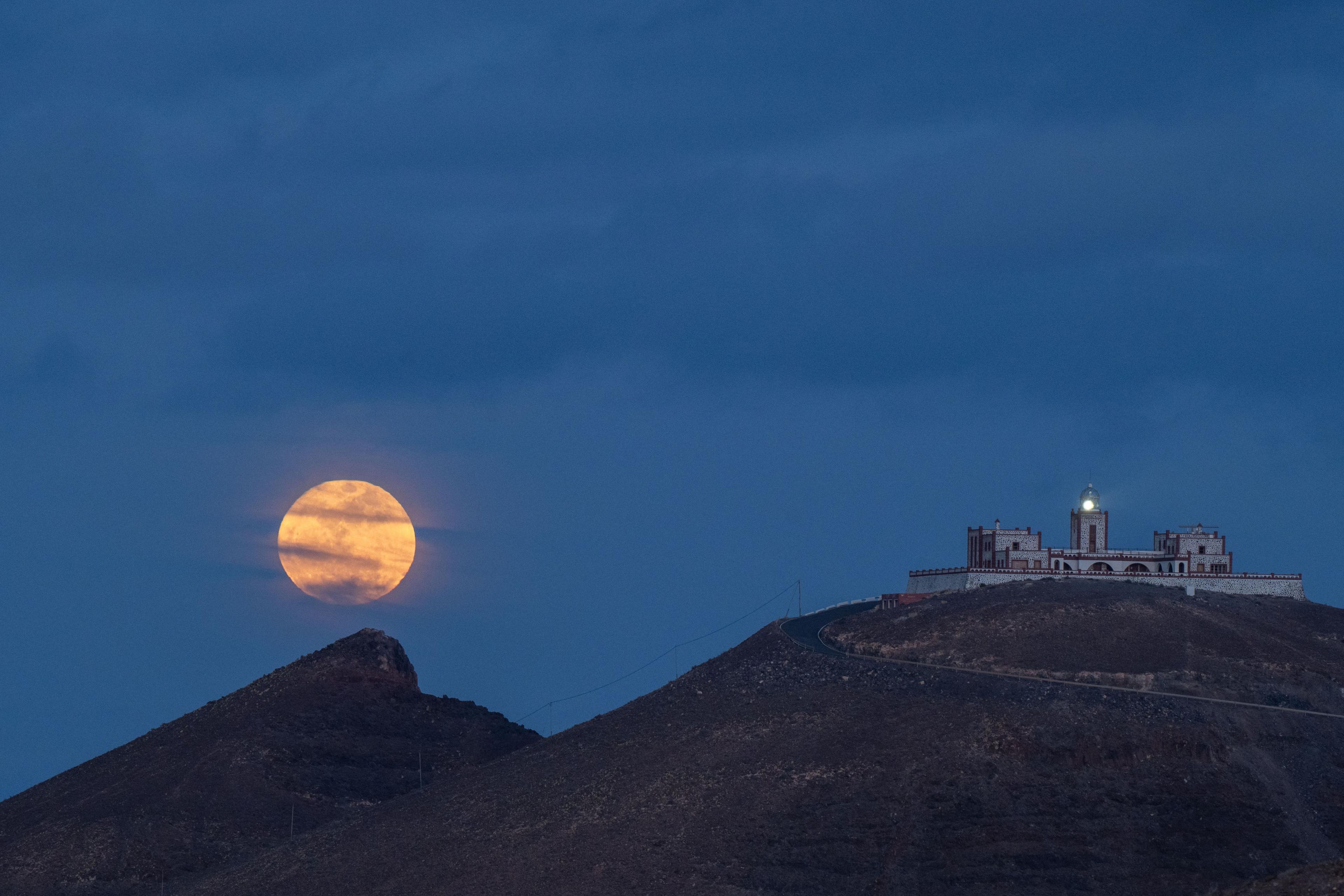 A full moon is seen next to Entallada lighthouse in Tuineje, Fuerteventura, Canary Islands, Spain, 12 May 2025
