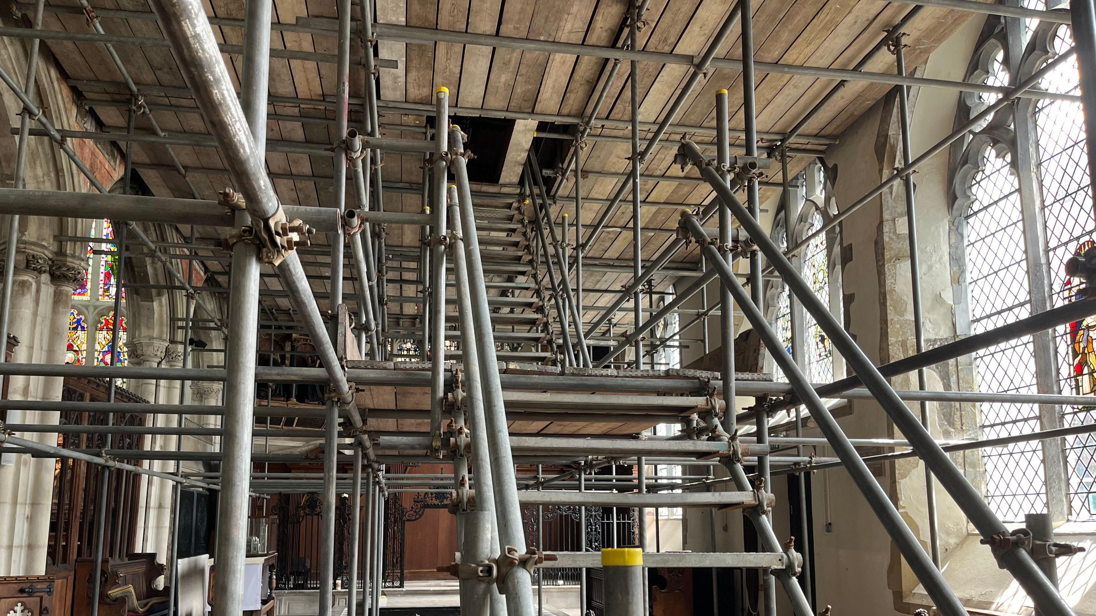 A view upwards of scaffolding - but large and wide, with a full set of metal stairs.