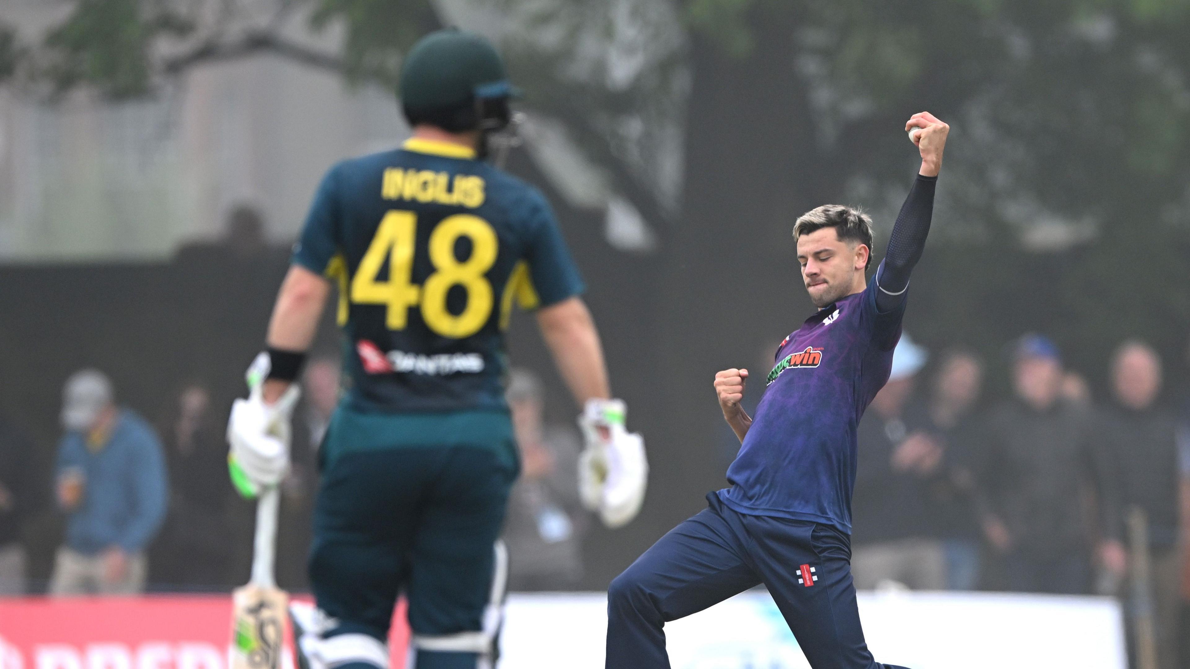 Brad Currie celebrates taking the wicket of Australia's Josh Inglis