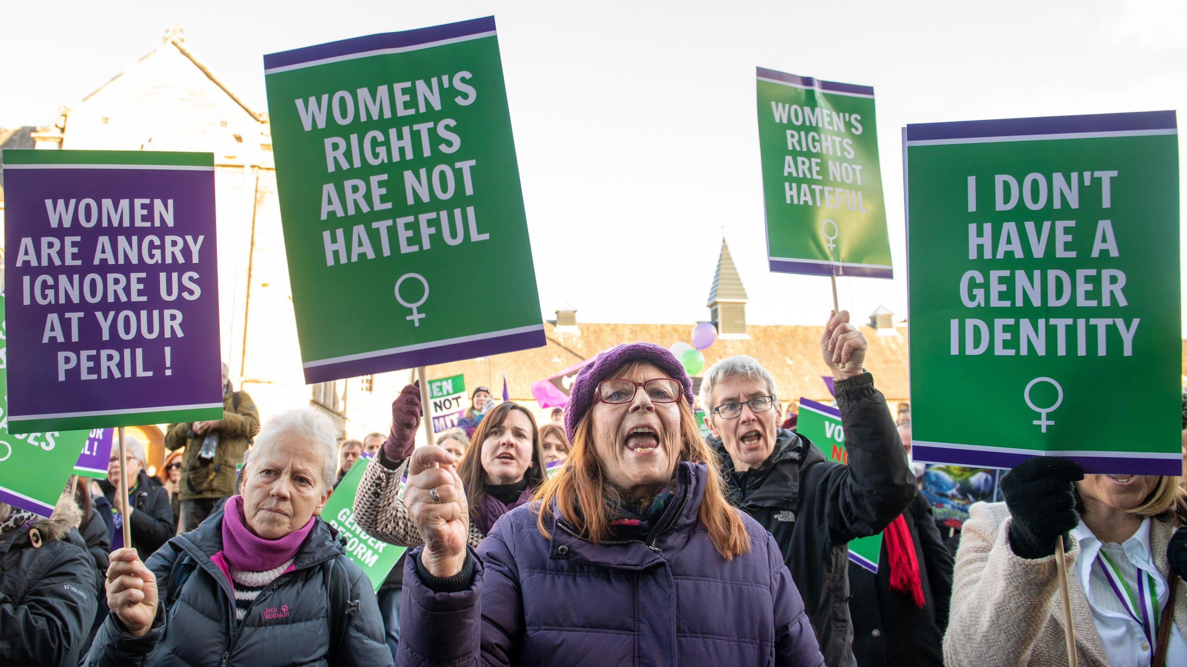 Protest outside the Scottish Parliament by women's rights campaigners, holding placards reading "women are angry, ignore us at your peril", "women's rights are not hateful", and "I don't have a gender identity"