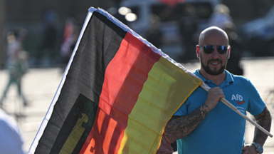 AfD supporter holds a German flag