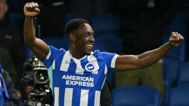 Danny Welbeck punches the air with both hands after scoring for Brighton