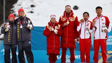 The medallists of the women's sprint classic vision impaired event on the podium, with a clear gap visible between the Germans and the Russians