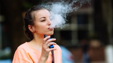 A young woman vaping