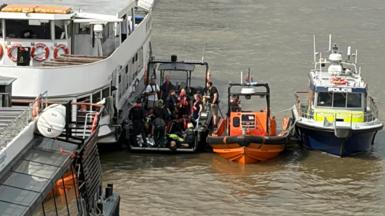 Rescue boats and a Met Police boat next to each other in the Thames. 