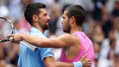 Novak Djokovic and Carlos Alcaraz embrace after their 2025 US Open quarter-final