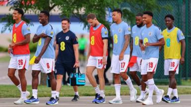 England players head to the pitch to warm up before a friendly against Sporting Kansas City