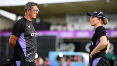 Former England coach Jon Lewis (left) in discussion with captain Heather Knight