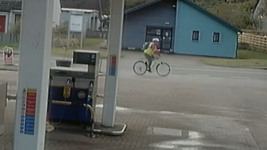 A CCTV image of a cyclist taken from the forecourt of a garage