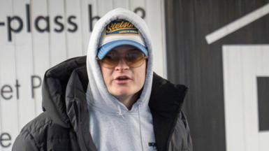 A young man called Marius Borg Hoiby wearing warm clothes and a cap and sunglasses