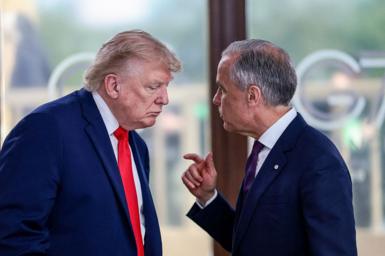 US President Donald Trump speaks with Canada's Prime Minister Mark Carney during a work lunch as part of the G7 summit, in Evian, eastern France, on 16 June 2026.