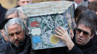 Alan Wren aka 'Reni' of the Stone Roses & Liam Gallagher help carry the coffin out of the funeral of Gary Mounfield, also known as Mani, at Manchester Cathedral on December 22, 2025 in Manchester, England. Mani is know for being the bass guitarist in rock bands The Stone Roses and Primal Scream. He died on November 20, 2025 at the age of 63 after suffering from a long-standing lung condition.