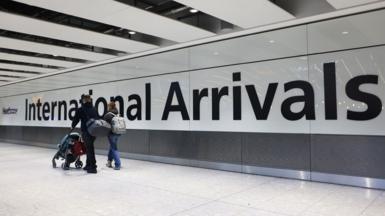 Airline passengers in the arrivals hall at Heathrow Airport in London