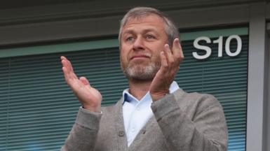 Roman Abramovich clapping while watching Chelsea play Leicester in 2016 at Stamford Bridge.