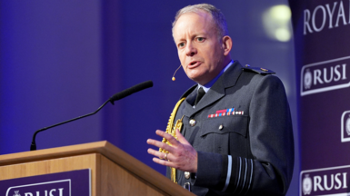 Sir Richard Knighten speaks at a podium. He is wearing military uniform 