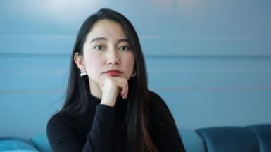 Shiori Ito - a young woman with long, dark hair, staring straight at the camera, her left hand resting under her chin.  She is pictured at the Filmmakers Afternoon Tea during the 68th BFI London Film Festival at Sea Containers London on 11 October, 2024 