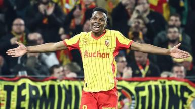 Mamadou Sangare pictured with his arms outstretched while playing for Lens