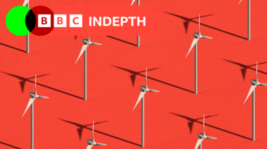 Wind turbines on a red background