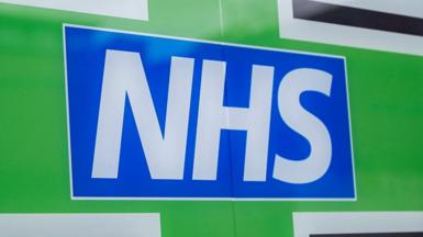 NHS logo.