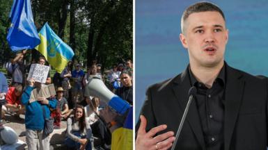 People protest against the replacement of former defense minister Mykhailo Fedorov, and a picture of Fedorov on the right