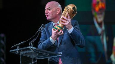 FIFA president Gianni Infantino holds the FIFA World Cup trophy