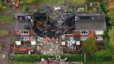 An aerial of the scene showing what appears to be houses destroyed by an explosion