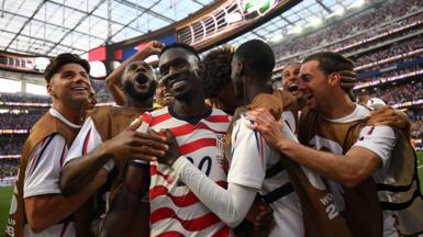 USA players celebrate scoring against Paraguay