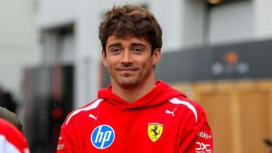 Charles Leclerc poses in the paddock ahead of the Canadian Grand Prix