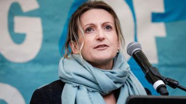 A file photo of Melissa Green speaking into a microphone during an event.