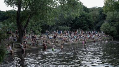 Scenes of the Hampstead Heath bathing ponds in North London during a historic heat wave in London