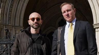 Carlo Palombo and Tom Hayes stand outside the Royal Courts of Justice