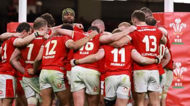 Wales players in a huddle after defeat to Australia