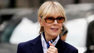 A head and shoulders portrait of Carroll wearing sunglasses while leaving the Court of Appeals in New York in 2024, with a bokeh background