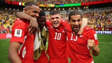 Switzerland players celebrate beating Colombia