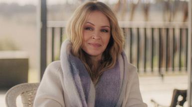 Kylie Minogue smiling at the camera while wearing a fur coat in the new three-part Netflix documentary, Kylie
