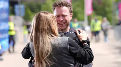Singer Olly Murs crosses the finish line crying and hugging a woman after a five-day 400km challenge finishing at London Stadium, east London, marking Soccer Aid for Unicef's 20th Anniversary.