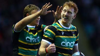 George Hendy in a Saints shirt with a clenched fist