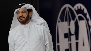 FIA president Mohammed Ben Sulayem should in front of an FIA logo