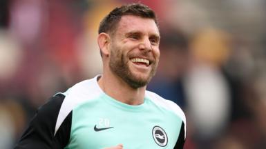 James Milner smiles in Brighton shirt.