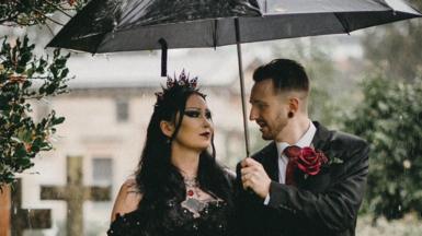 Hannah and Mathew pose for wedding photos in a cemetery