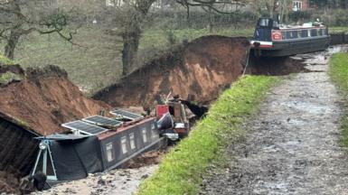 two canals in a sink hole with one balancing on the edge of a drop of earth