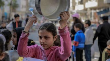 A Palestinian girl protests against food shortages in Gaza City on 12 March, 2024.