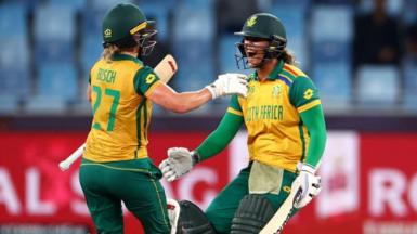 South Africa batters Anneke Bosch and Chloe Tryon celebrate winning the semi-final of the Women's T20 World Cup v Australia