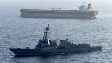 A US military ship is seen in the foreground in the Arabian Sea in April, while another ship is seen in the background.