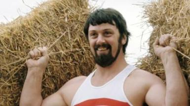 Geoff Capes lifting bales of hay