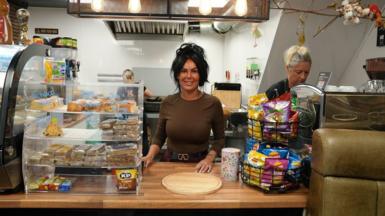 Yasmin Ratcliffe, owner of Rose's Cafe, stands behind the counter in Ashton-in-Makerfield